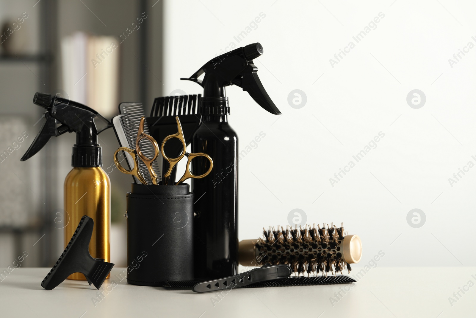 Photo of Set of hairdresser tools on table in salon, space for text