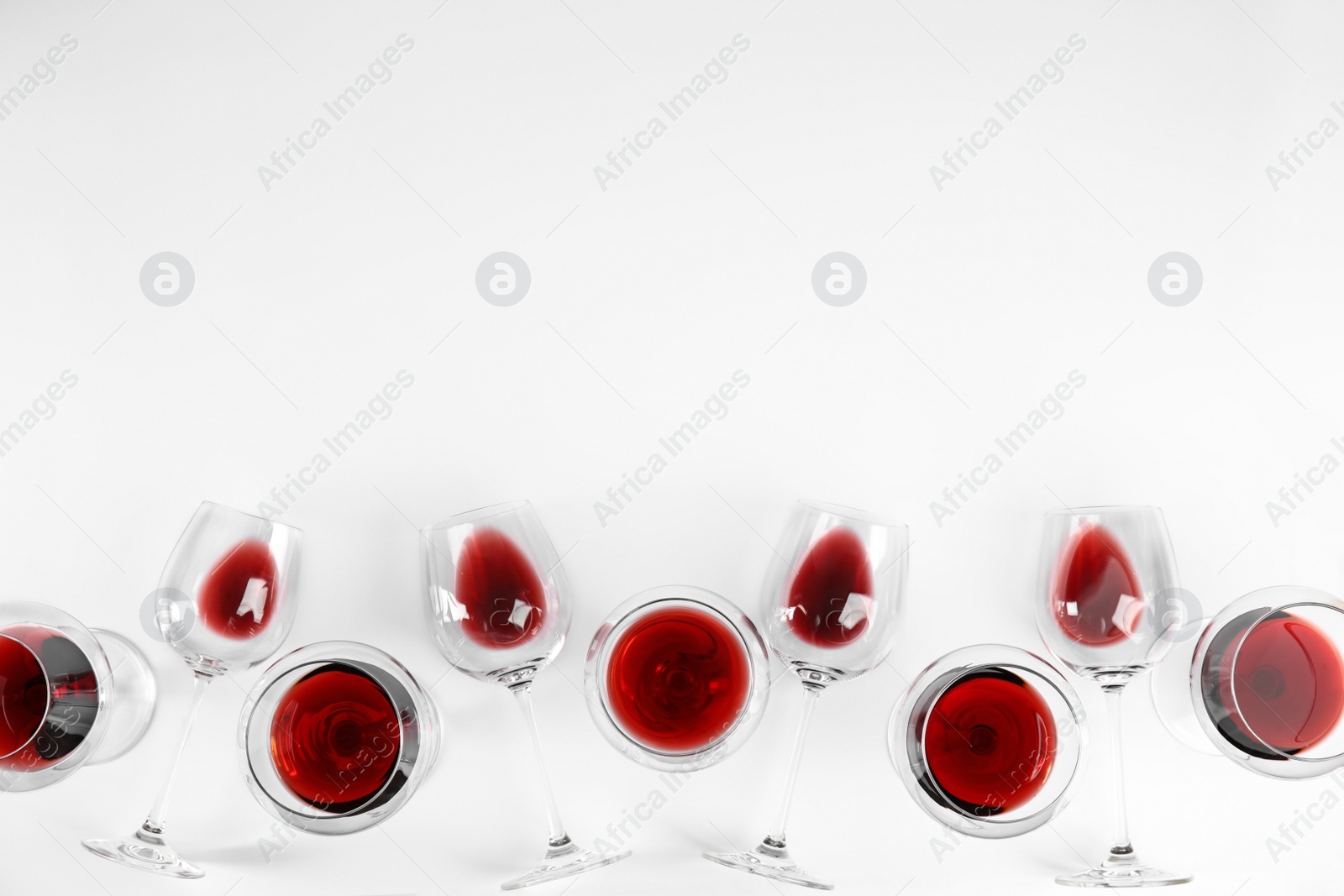 Photo of Composition with glasses of wine on white background, top view