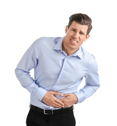 Young man suffering from abdominal pain on white background