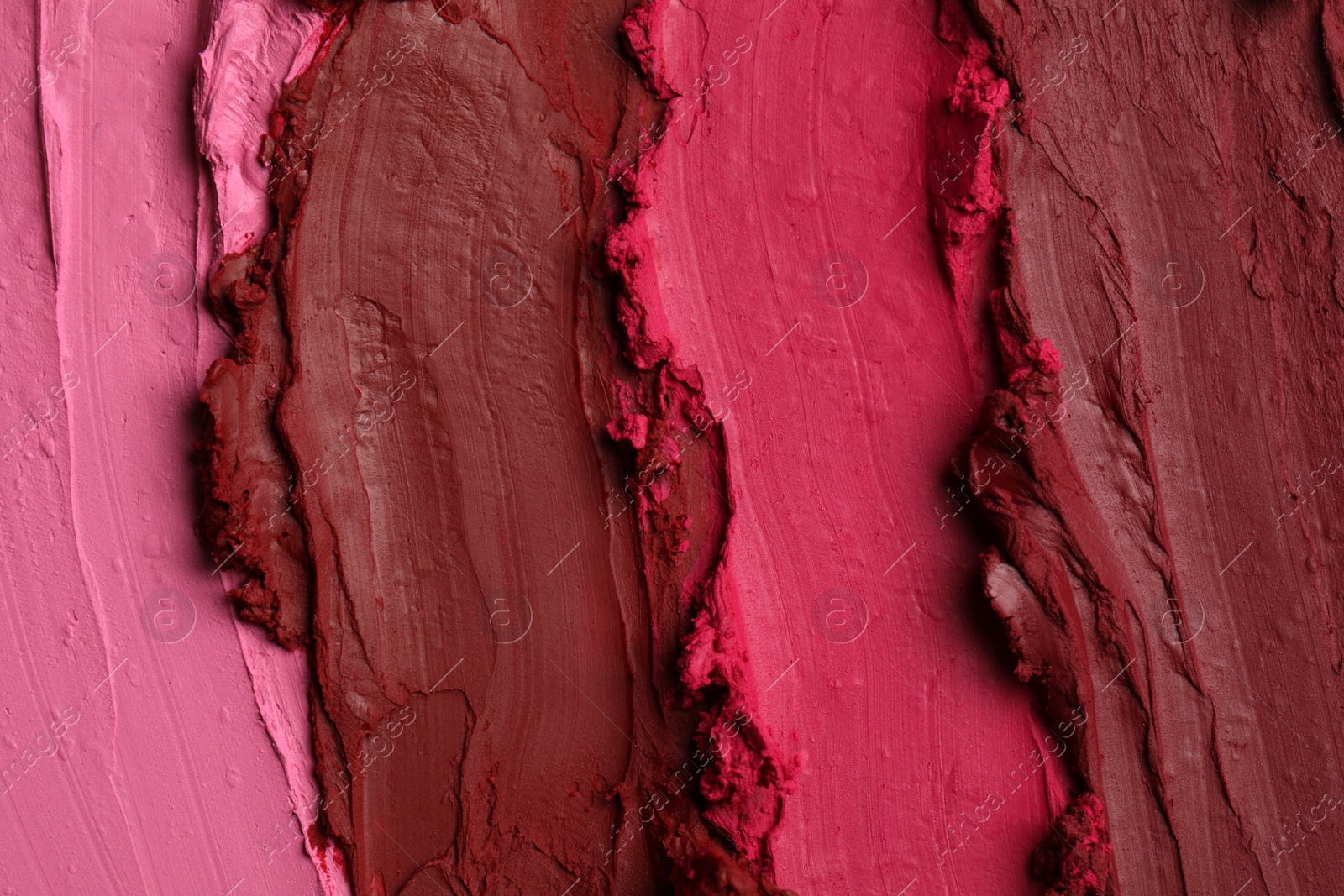 Photo of Texture of beautiful lipsticks as background, top view