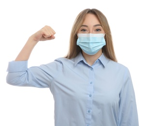 Photo of Woman with protective mask showing muscles on white background. Strong immunity concept