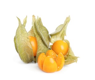 Cut and whole physalis fruits with dry husk on white background