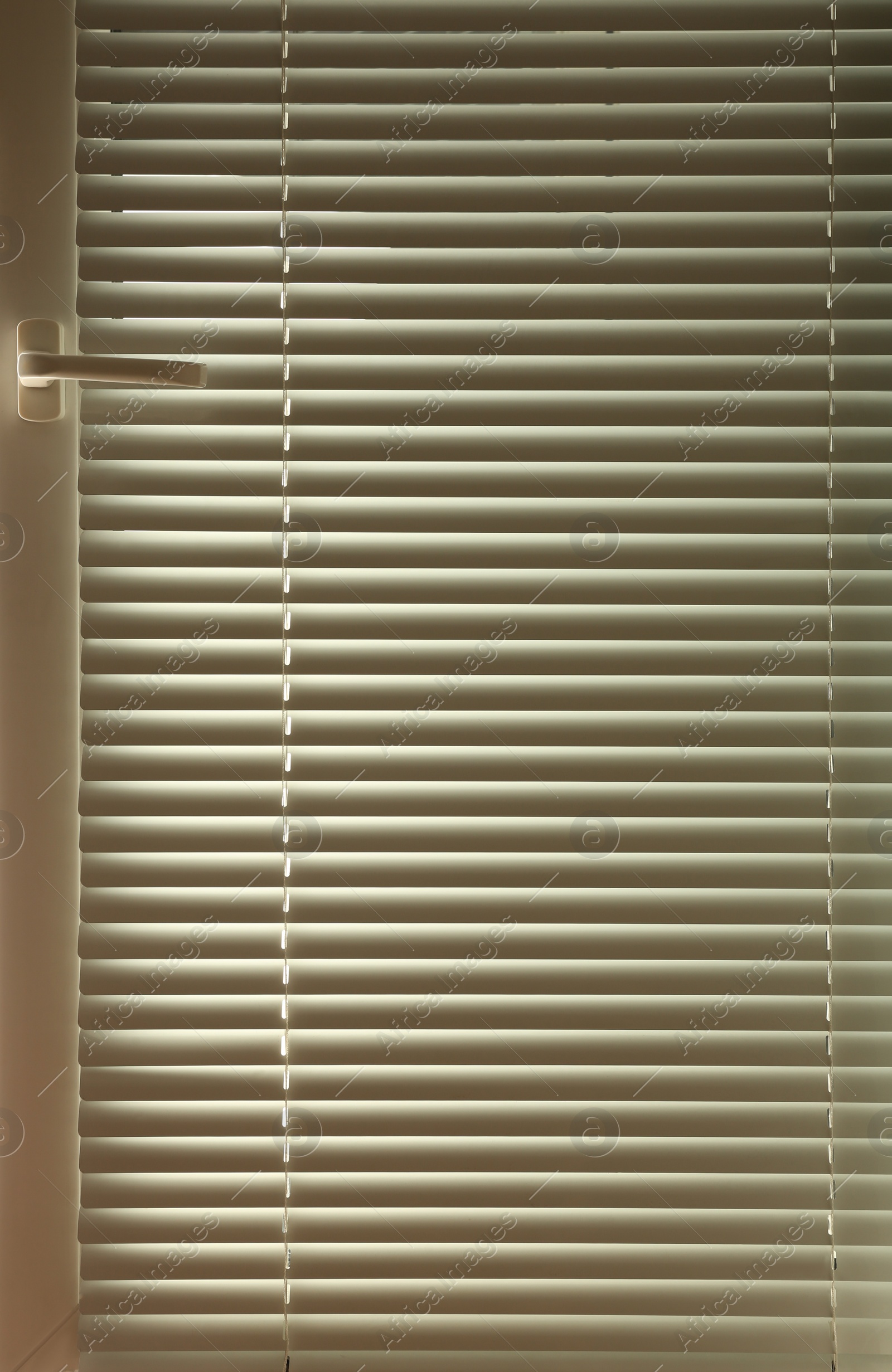 Photo of Modern window with closed stylish white blinds