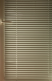 Photo of Modern window with closed stylish white blinds