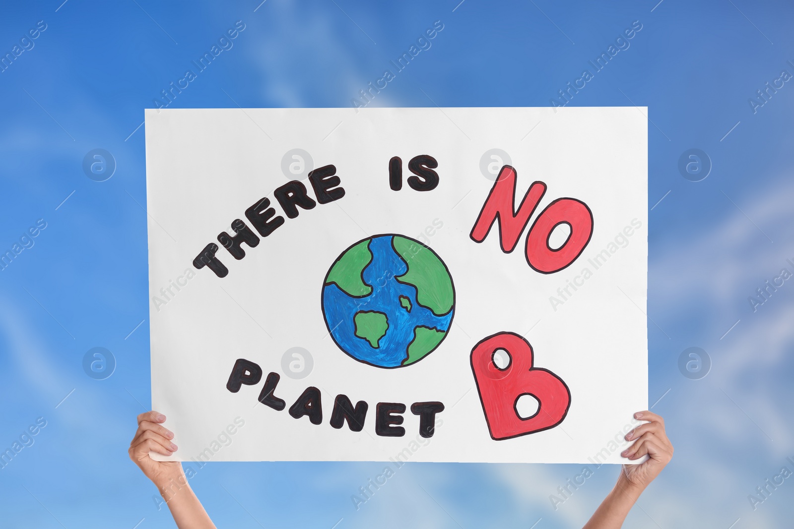 Image of Protestor holding placard with text There Is No Planet B against blue sky, closeup. Climate strike