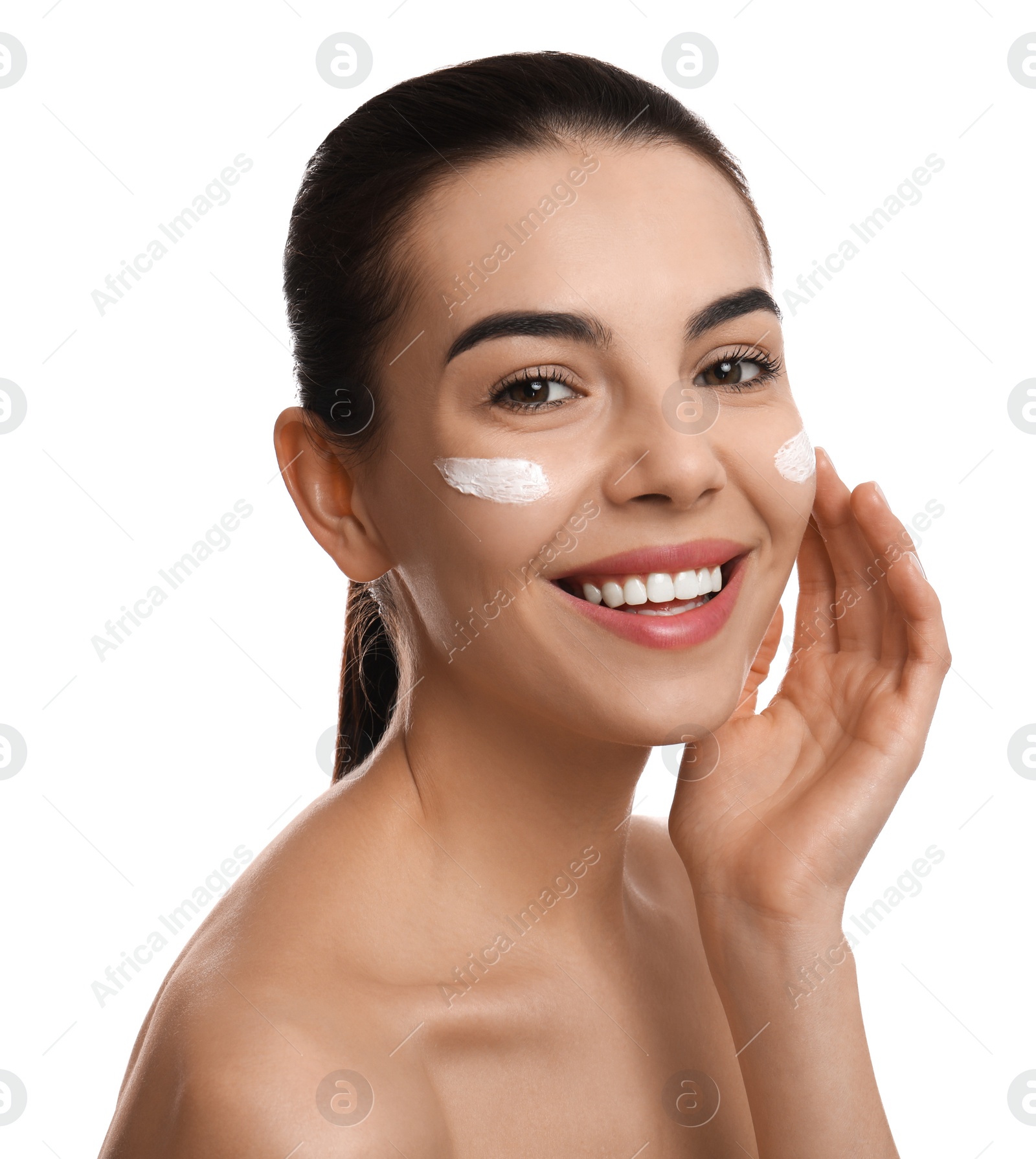 Photo of Young woman applying facial cream on white background