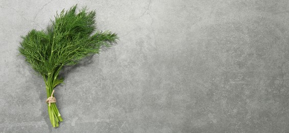 Image of Fresh dill on grey table, top view. Banner design with space for text