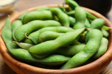 Photo of Bowl with green edamame beans in pods, closeup