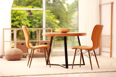Photo of Modern dining room interior with table and chairs