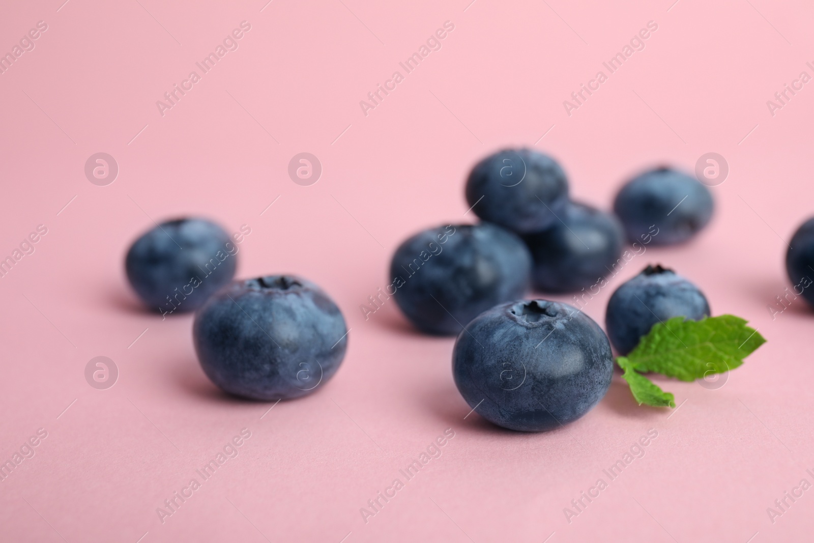 Photo of Tasty ripe blueberry on color background, closeup