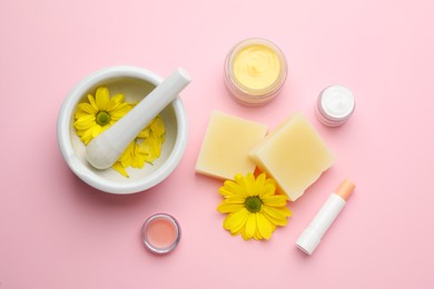 Photo of Flat lay composition with beeswax and cosmetic products on pink background