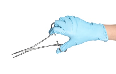 Doctor in sterile glove holding medical clamp on white background