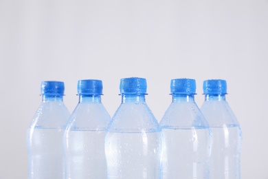 Photo of Plastic bottles with pure water on white background