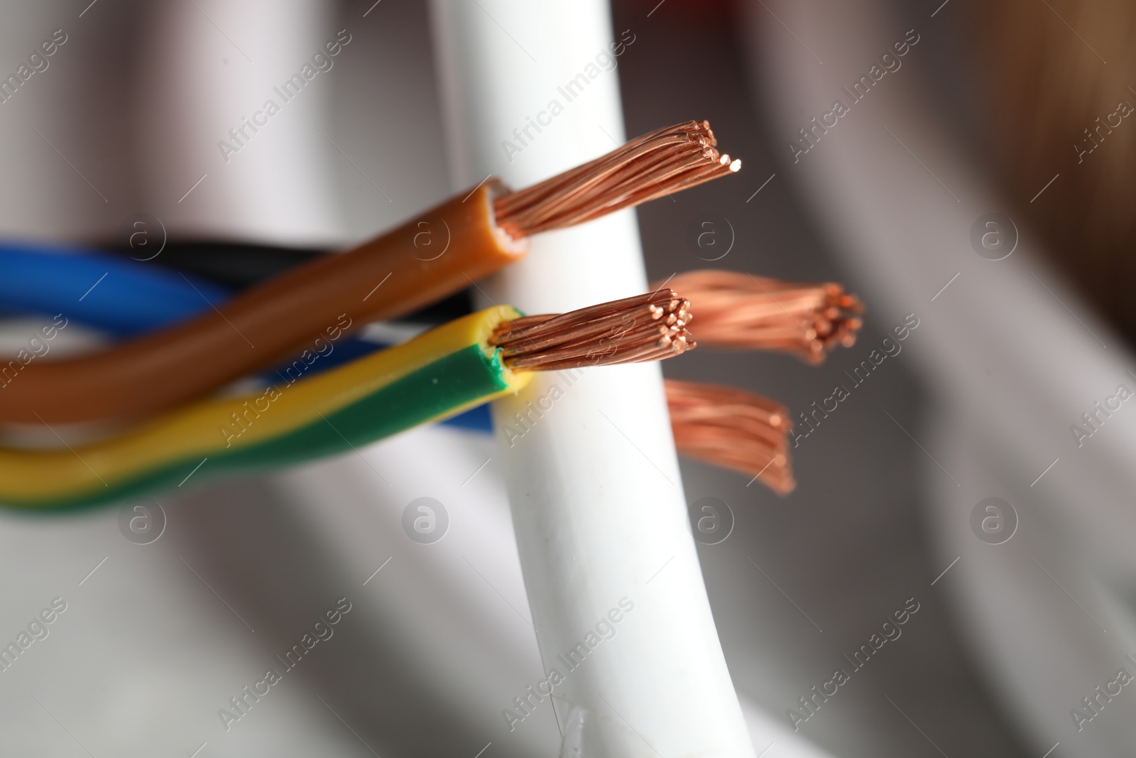 Photo of Colorful electrical wire on blurred background, closeup