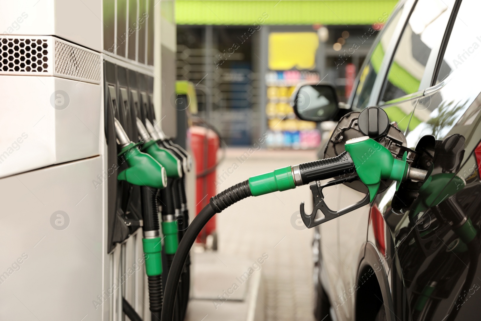 Photo of Refueling modern car at gas filling station, closeup