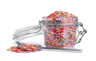 Photo of Colorful sprinkles and glass jar on white background. Confectionery decor