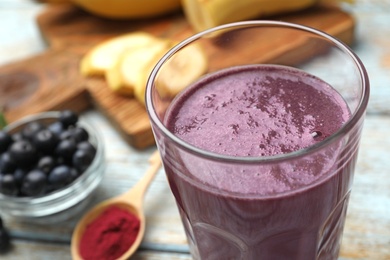 Tasty fresh acai drink on wooden table, closeup