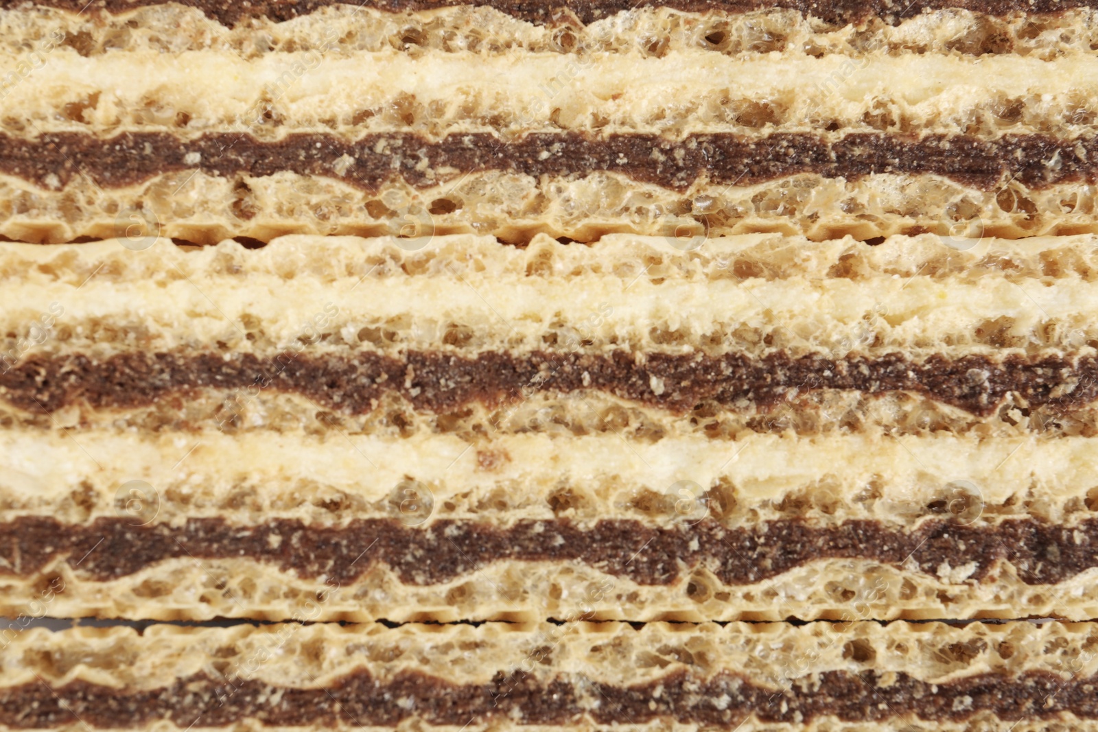 Photo of Wafer sticks with chocolate filling as background, closeup. Sweet food