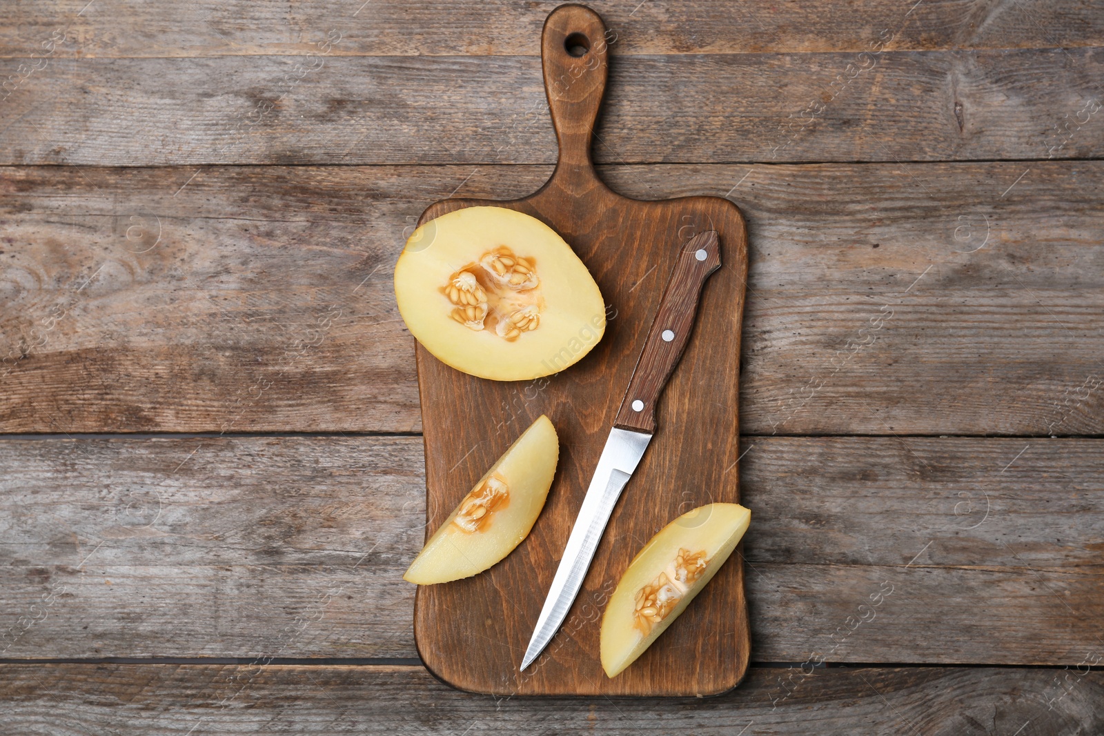 Photo of Flat lay composition with sliced ripe melon on wooden background