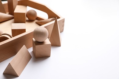 Photo of Set of wooden geometrical objects in box on white background. Montessori toy