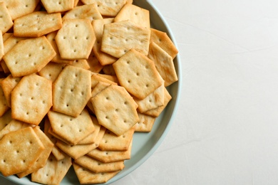 Photo of Top view delicious crackers on light table, closeup