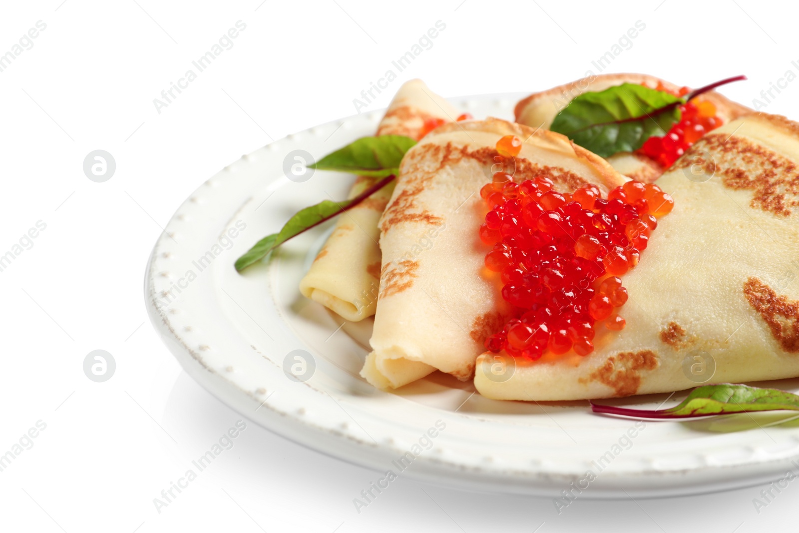 Photo of Thin pancakes with red caviar on plate against white background