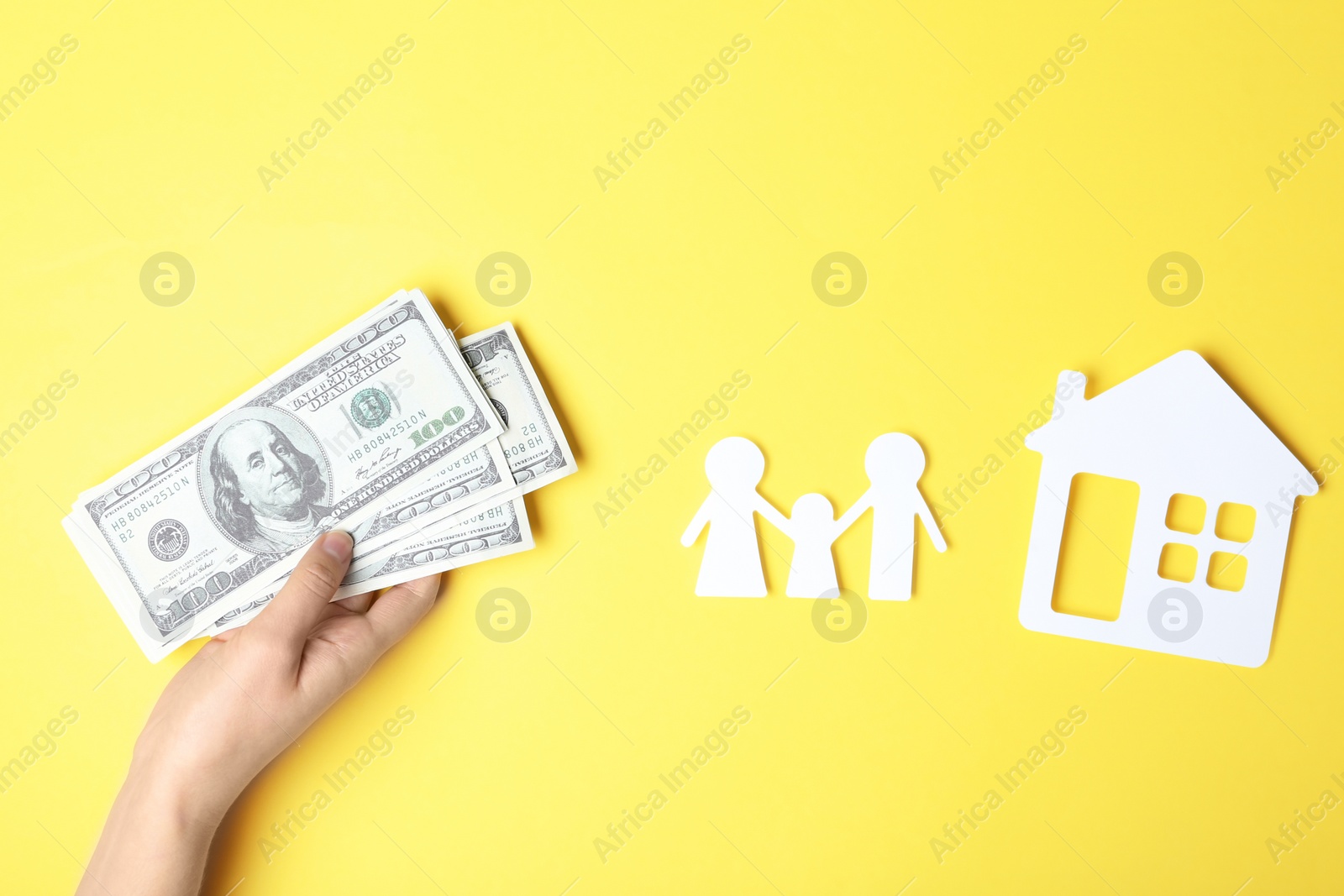 Photo of Woman with money and paper silhouettes of family and house on color background, top view. Life insurance concept