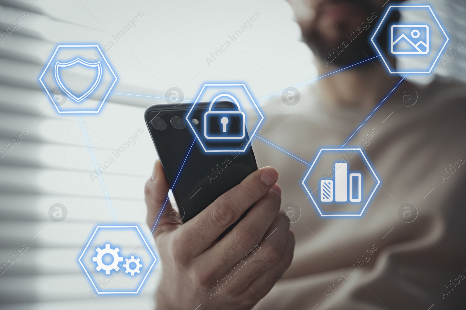 Image of Information security. Young man using smartphone indoors, closeup