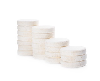 Photo of Stacks of vitamin pills on white background