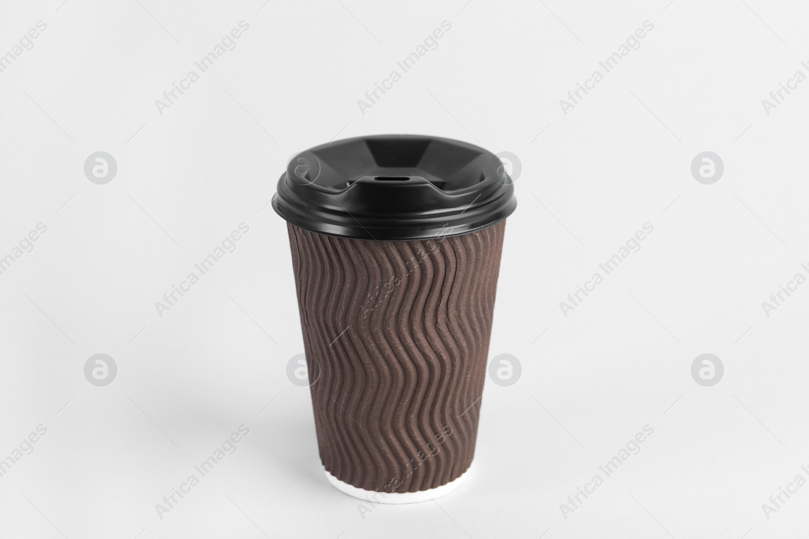 Photo of Brown paper cup with plastic lid on light background. Coffee to go