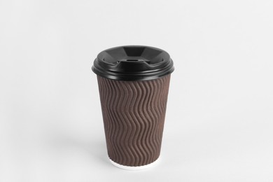 Photo of Brown paper cup with plastic lid on light background. Coffee to go