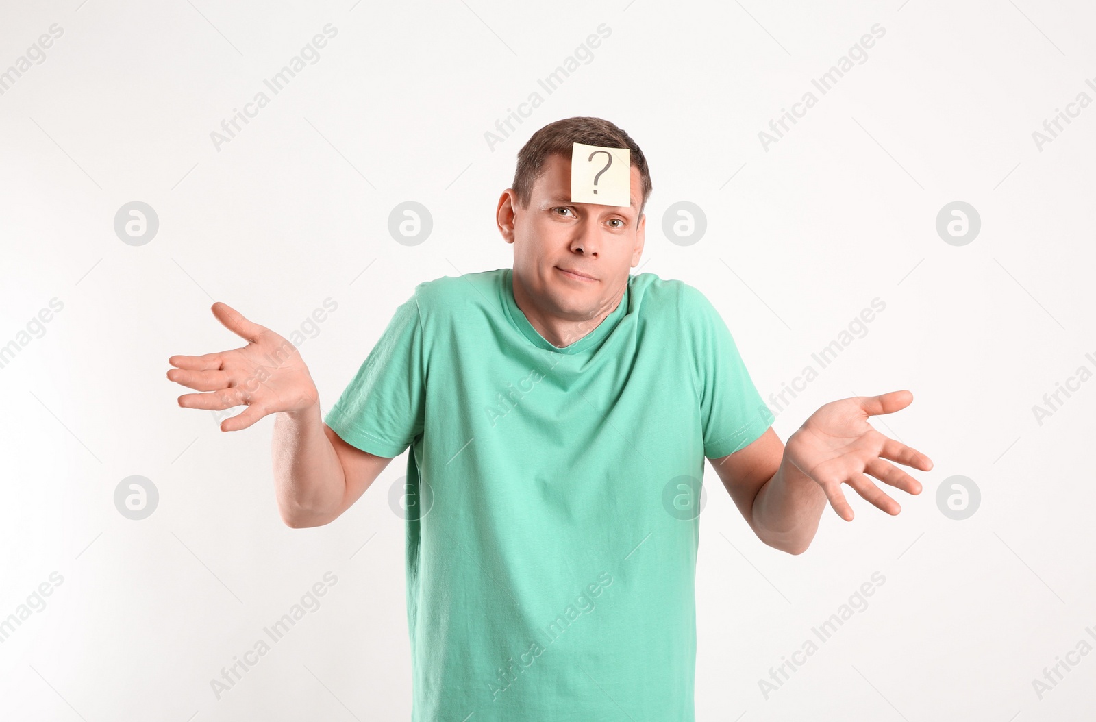 Photo of Emotional man with question mark on white background