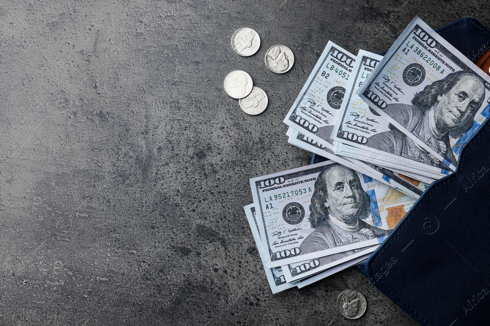 Photo of Dollar banknotes, wallet and coins on grey table, flat lay with space for text. Money exchange