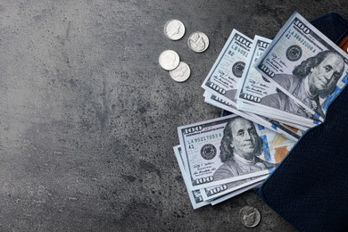 Dollar banknotes, wallet and coins on grey table, flat lay with space for text. Money exchange