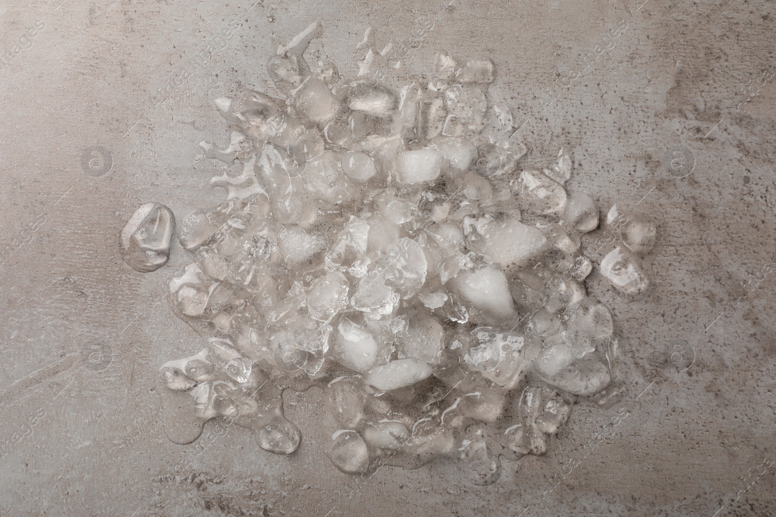 Photo of Pile of crushed ice on light grey table, top view