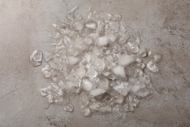 Pile of crushed ice on light grey table, top view