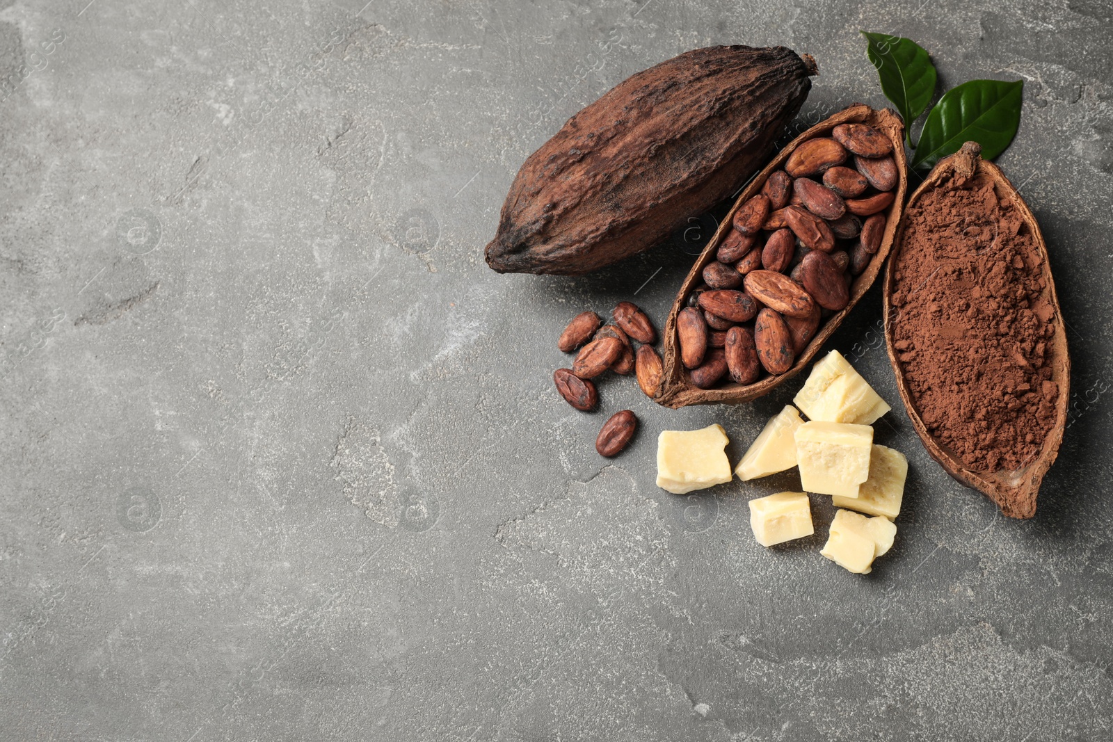 Photo of Flat lay composition with organic cocoa butter on grey table. Space for text