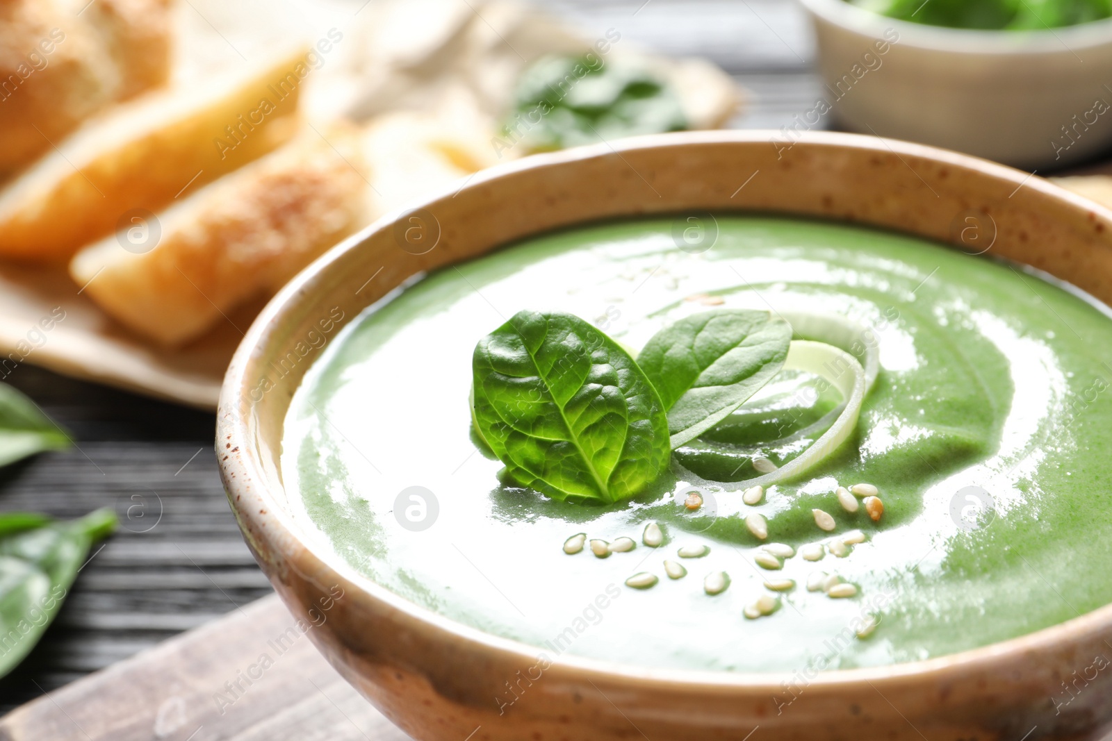 Photo of Fresh vegetable detox soup made of spinach in dish on table, closeup