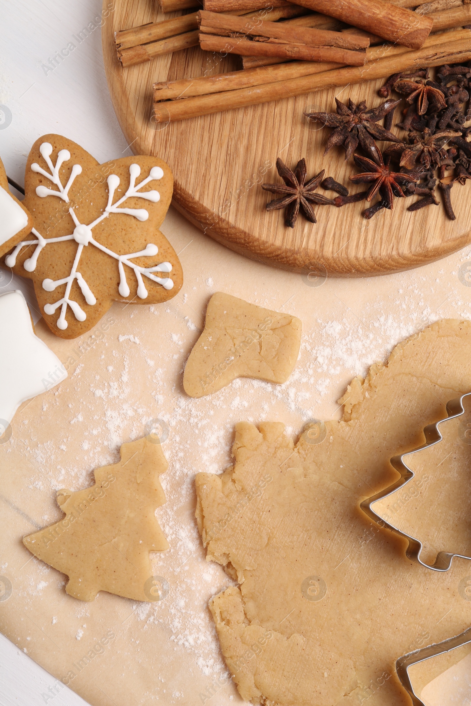 Photo of Making Christmas cookies. Flat lay composition with raw dough on white table