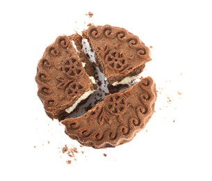 Broken tasty chocolate sandwich cookie with cream on white background, top view