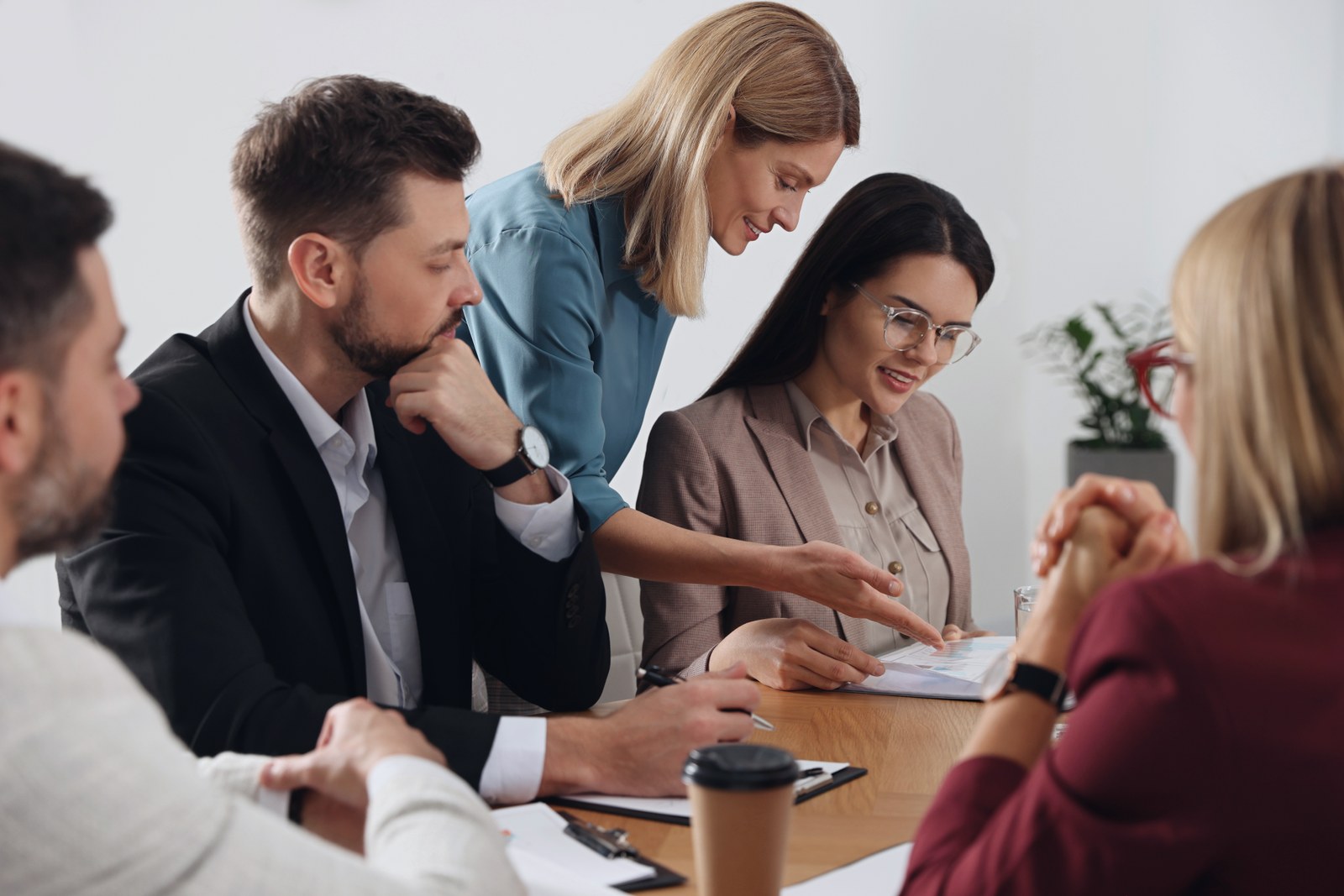 Businesswoman having meeting with her employees in office