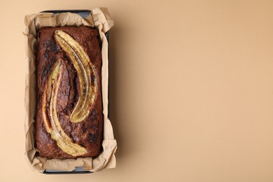 Photo of Delicious banana bread on beige background, top view. Space for text