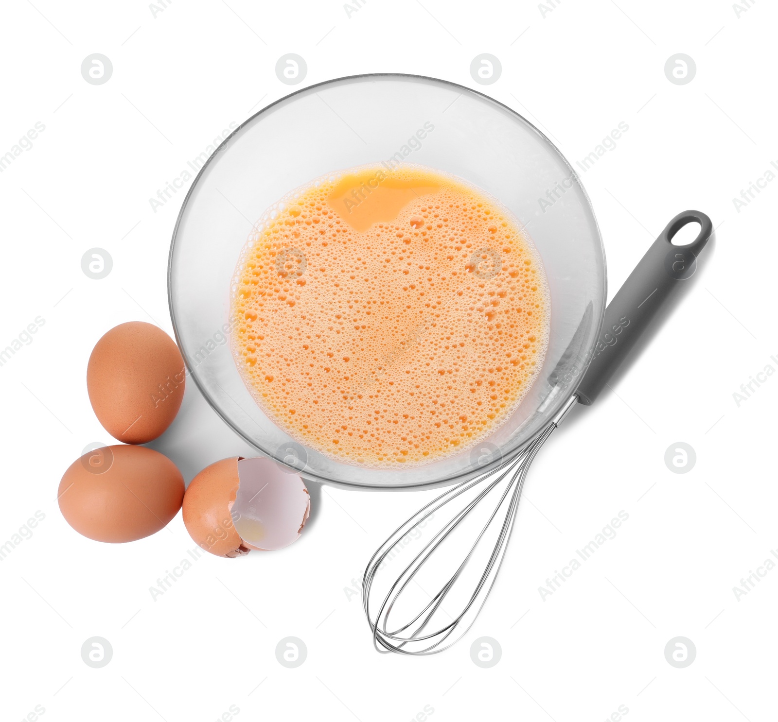 Photo of Metal whisk, beaten eggs in glass bowl and shells isolated on white, top view