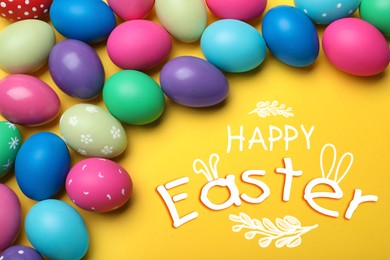 Image of Happy Easter. Bright painted eggs on yellow background, flat lay  