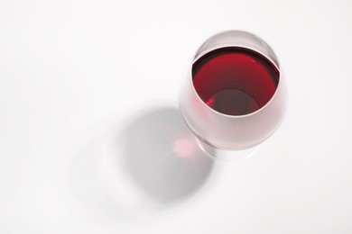 Tasty red wine in glass isolated on white, above view