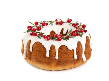 Photo of Traditional Christmas cake decorated with glaze, pomegranate seeds, cranberries and rosemary isolated on white