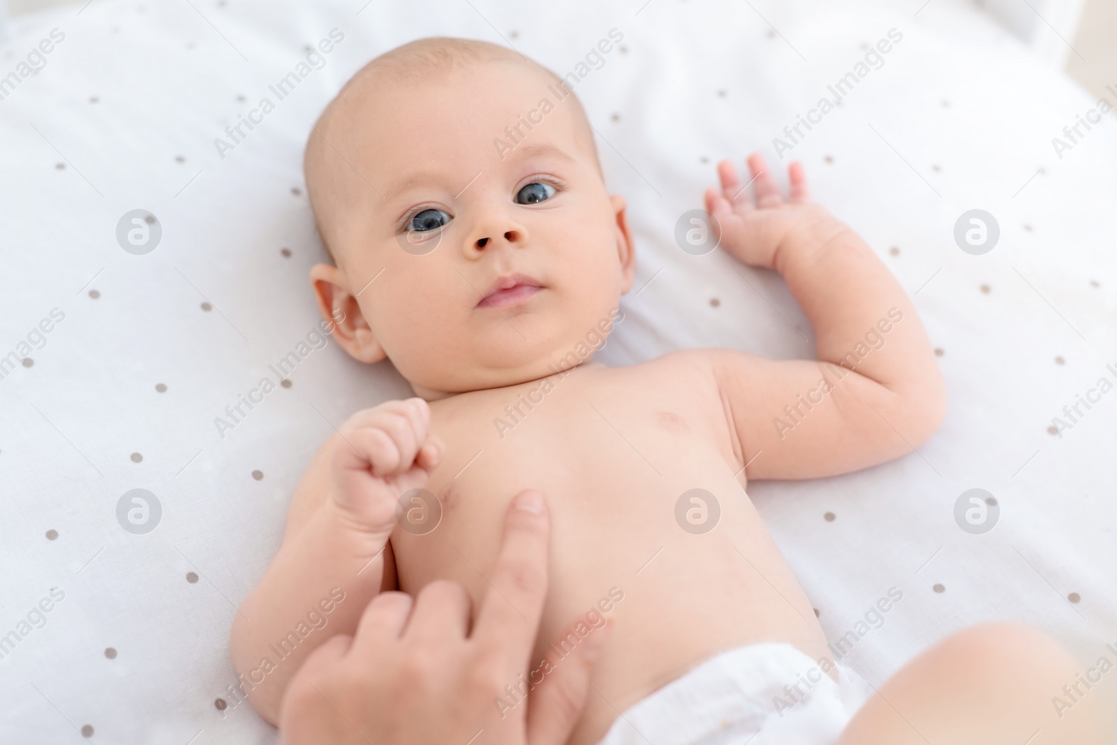 Photo of Mother with her cute little baby in crib