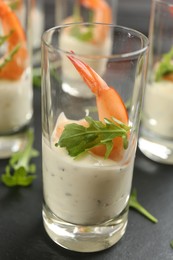 Photo of Delicious shrimp cocktail with tartar sauce served on table, closeup