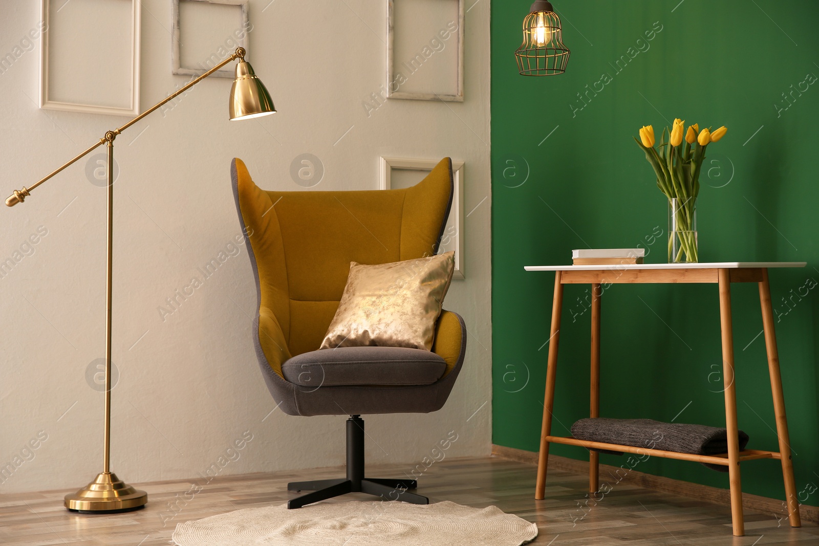 Photo of Modern interior with comfortable armchair and table near color wall