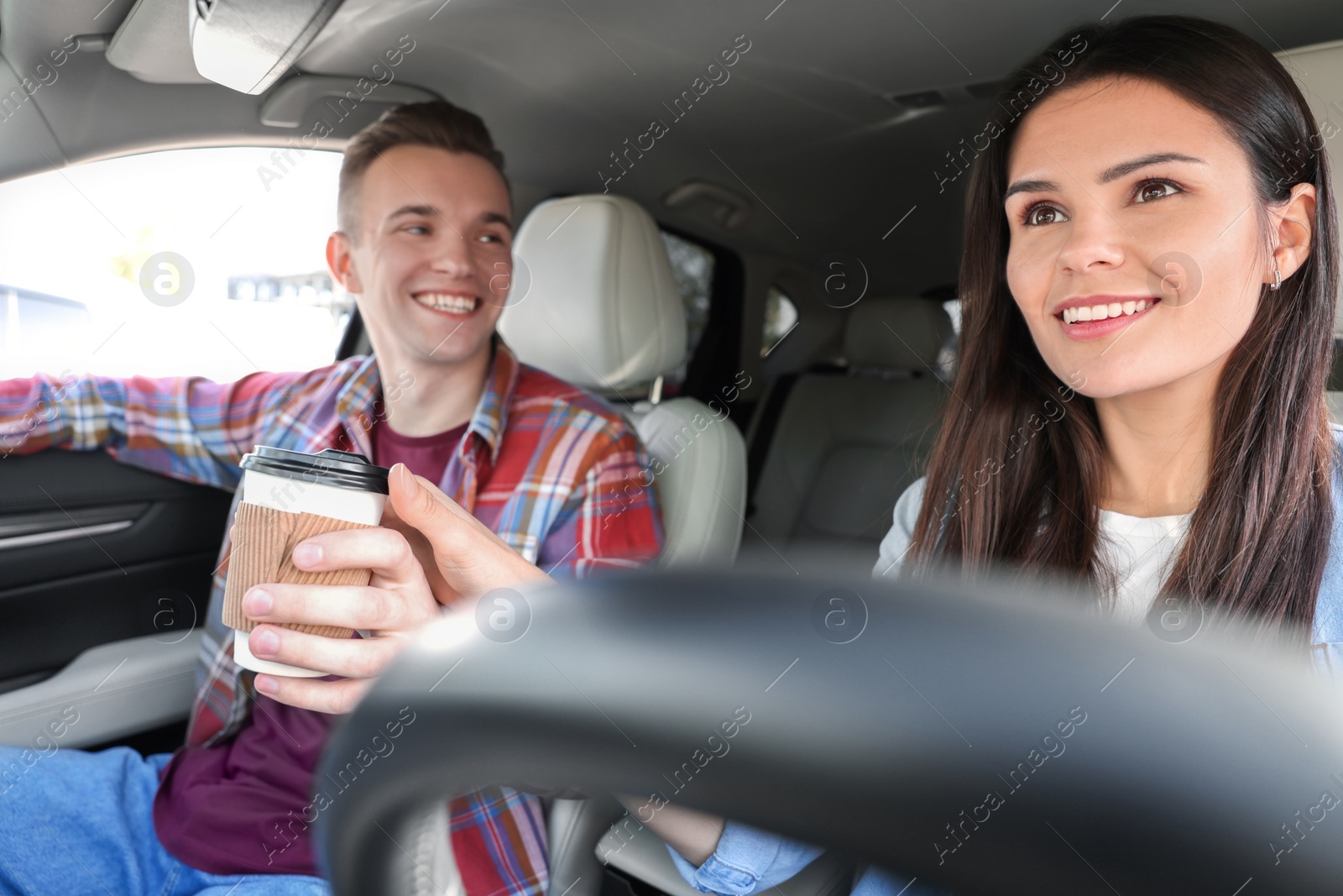 Photo of Happy young couple travelling together by car